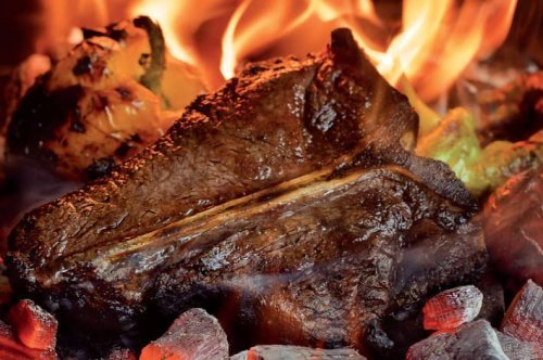 T-bone steak on coals, pepper hash.